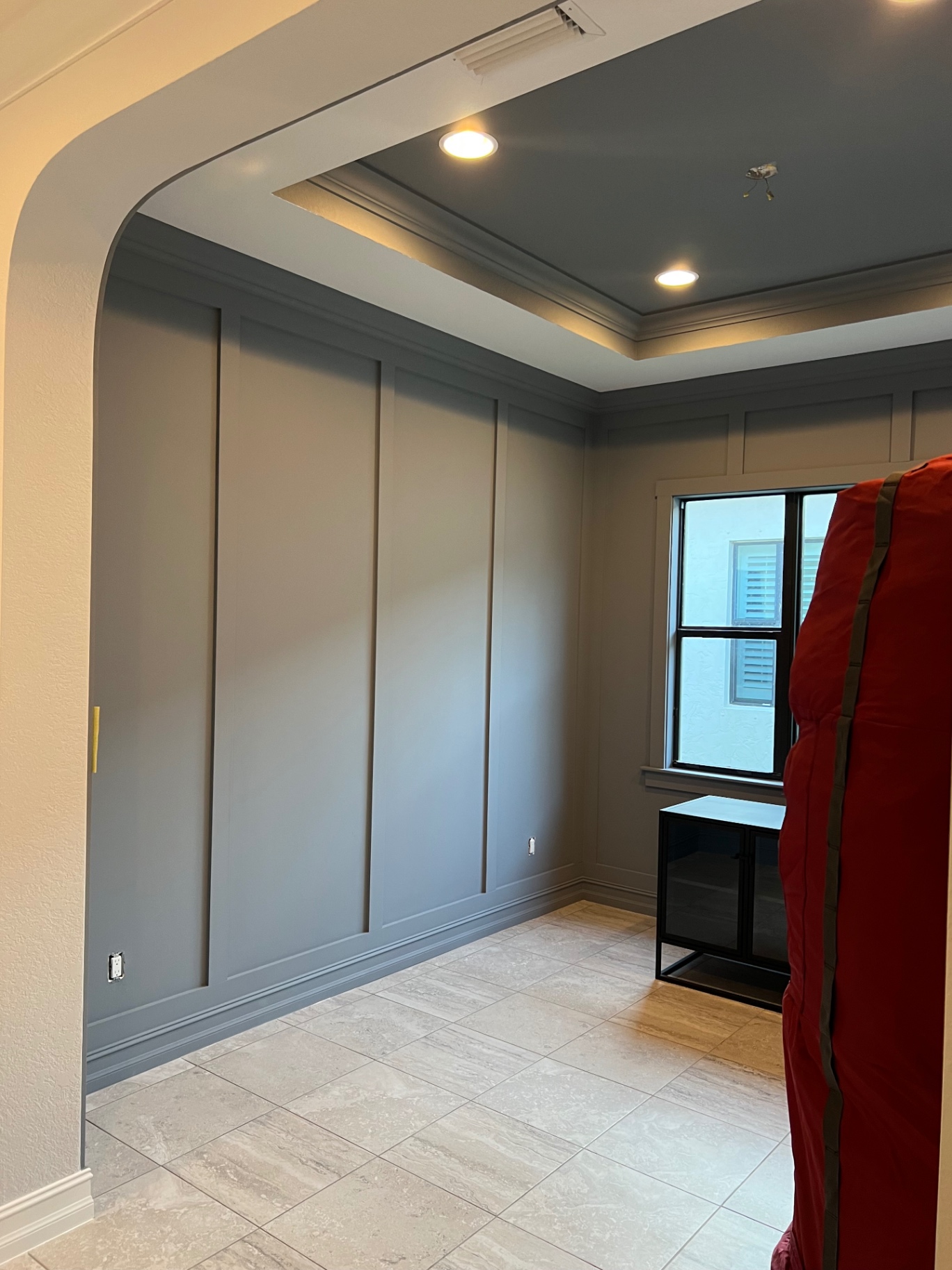 Bedroom renovation featuring board-and-batten accent wall and slate-blue tray ceiling